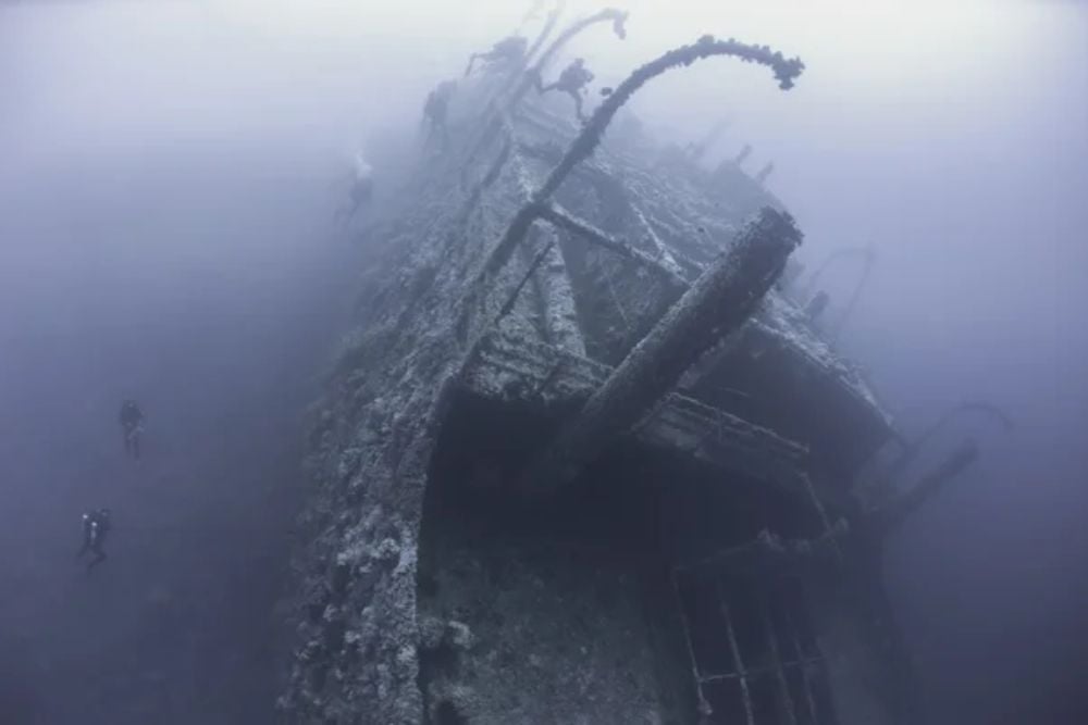 Divers on a deep underwater shipwreck — Stock Photo, Image