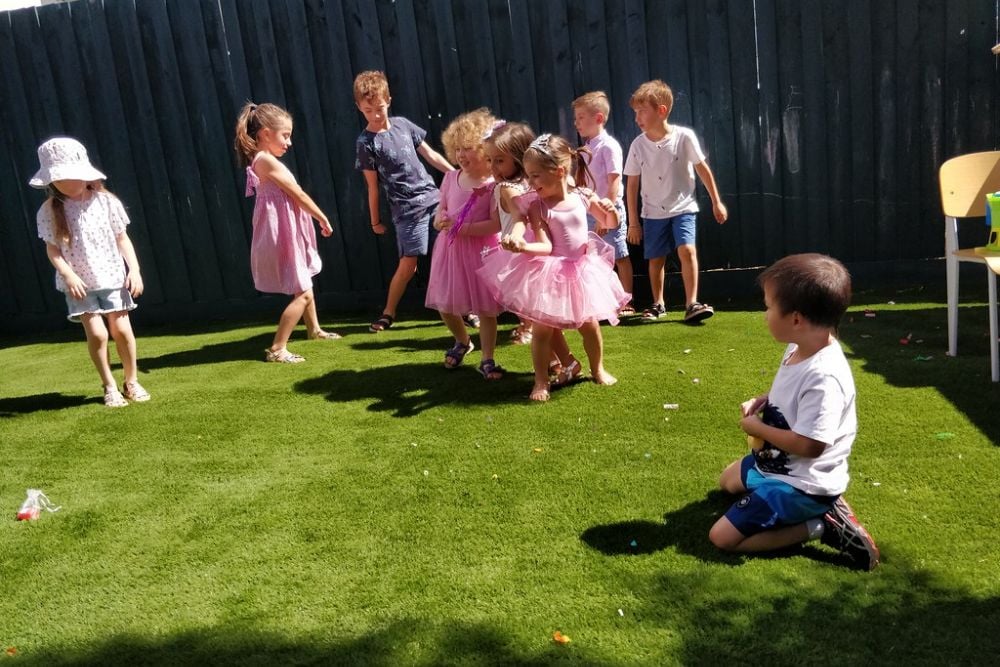 Liam collecting sequins while the kids play musical statue… | Flickr