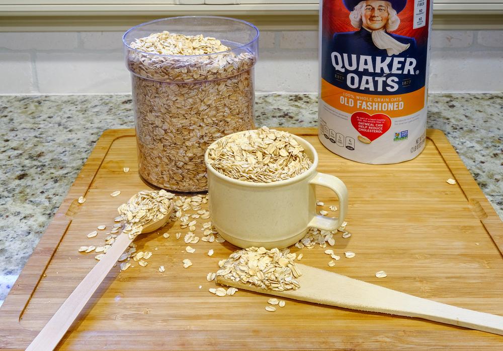 Quaker Oats Ready to Cook on a Wooden Cutting Board for Illustrative Editorial — Photo by dbvirago