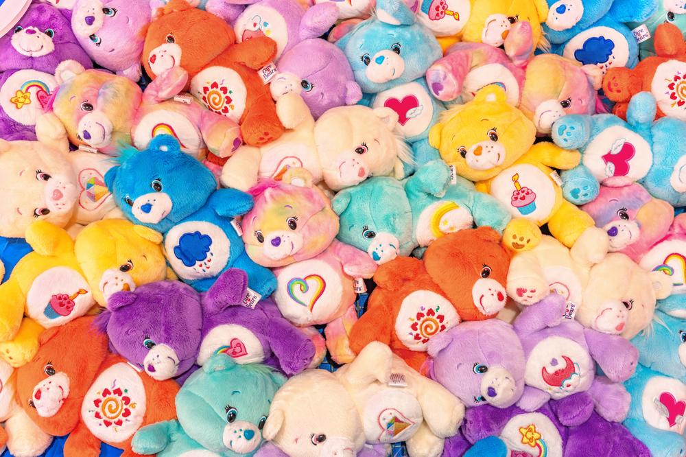 Tokyo, japan - apr 16 2024: Bunch of plushies of multi-colored Care Bears adorned with cute belly badge or tummy symbol for each one like heart, sun, cup cake, moon, rainbow created by Elena Kucharik. — Photo by kuremo