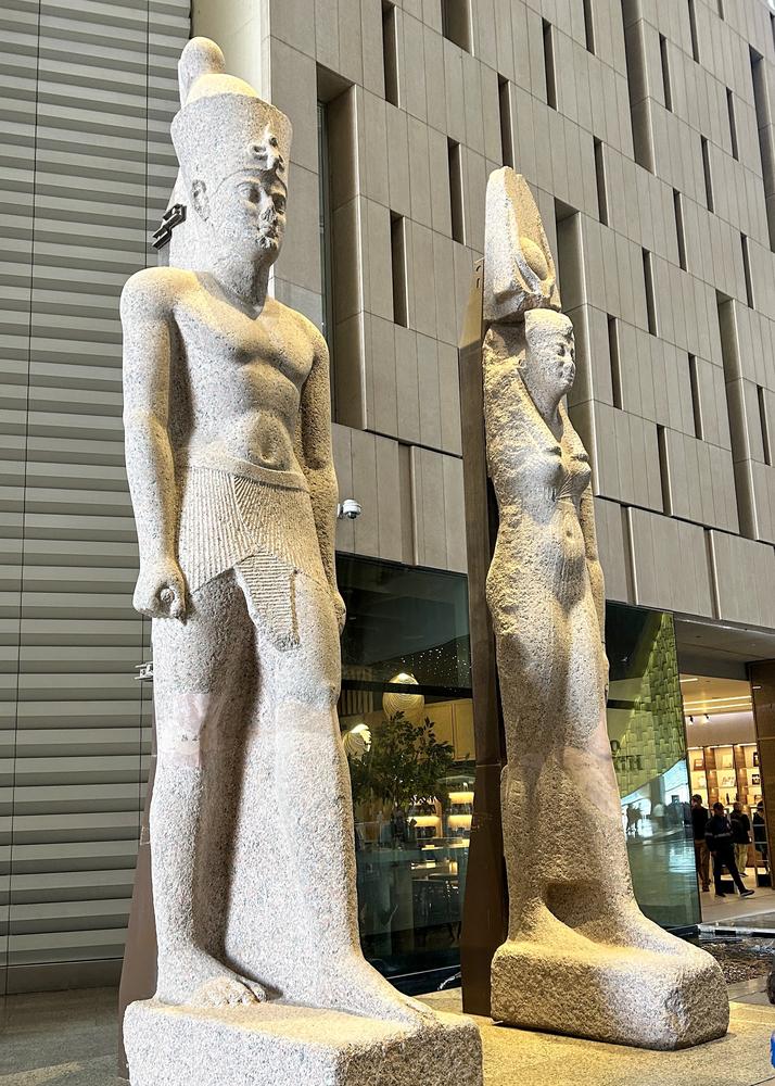 Massive statues of a Ptolemaic queen and king discovered in sunken Thonis-Heracleion, displayed at the Grand Egyptian Museum near Cairo. — Photo by mihirjoshi