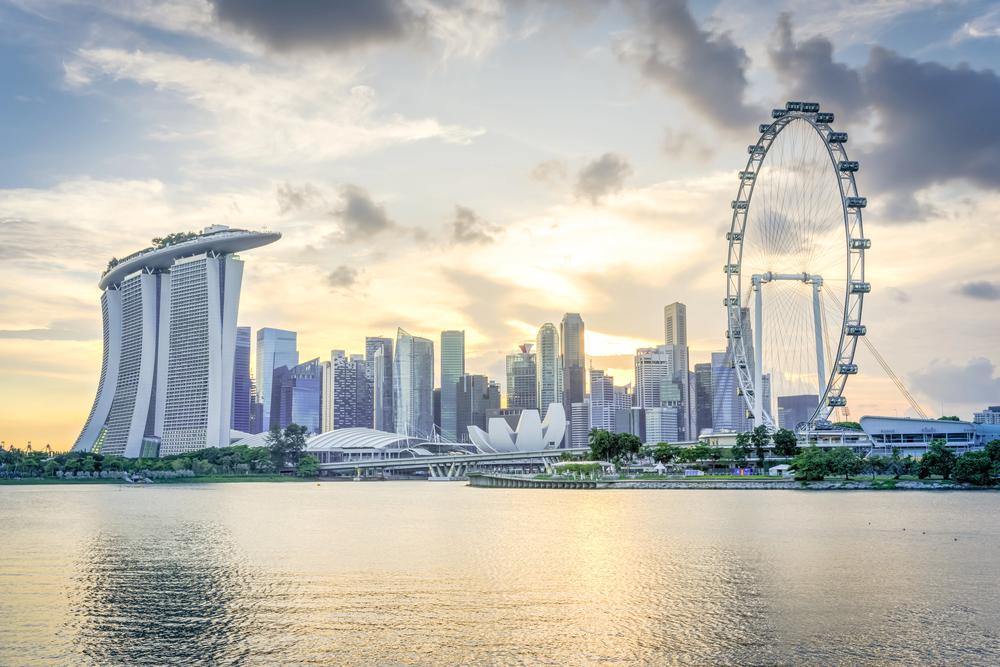 Famous Singapore flyer and downtown skyscrapers at sunset. View from Marina Bay East River bank. — Photo by trongnguyen