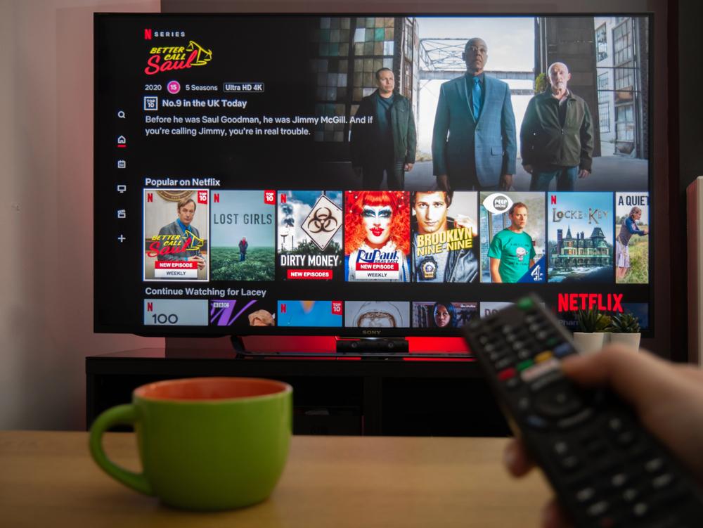 UK, March 2020: TV Television Netlfix menu with remote — Photo by Info@vantagedrones.co.uk